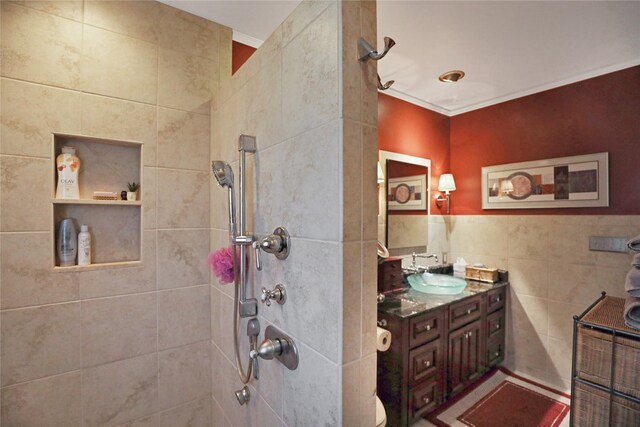 4027 Fagen Dr, Des Moines, IA 50310 - full bath with a tile shower, tile walls, and vanity
