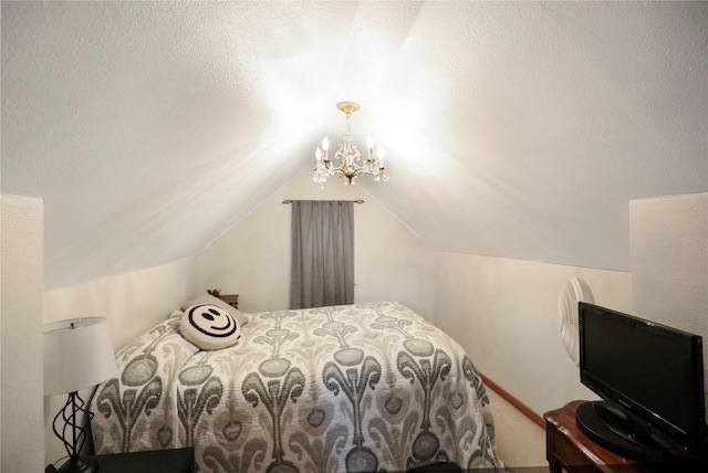 bedroom featuring a chandelier and lofted ceiling