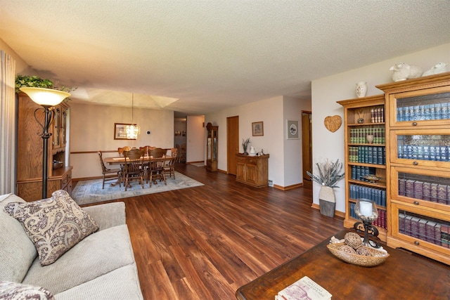 10760 Elmcrest Dr, Clive, IA 50325 - living room featuring a textured ceiling, wood finished floors, and baseboards