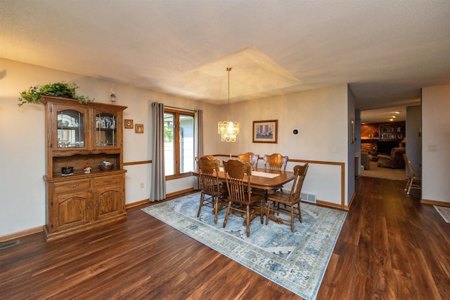10760 Elmcrest Dr, Clive, IA 50325 - dining area featuring dark wood-style flooring, baseboards, and a chandelier
