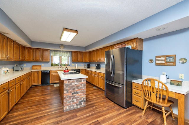 10760 Elmcrest Dr, Clive, IA 50325 - kitchen featuring stainless steel appliances, light countertops, dark wood-style floors, a center island, and brown cabinetry