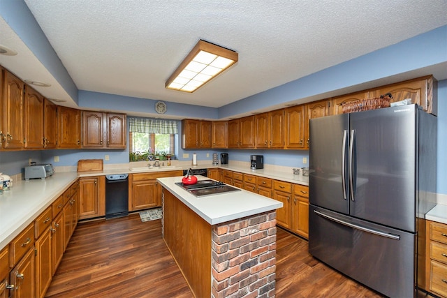 10760 Elmcrest Dr, Clive, IA 50325 - kitchen with freestanding refrigerator, black electric cooktop, brown cabinets, dark wood finished floors, and a textured ceiling