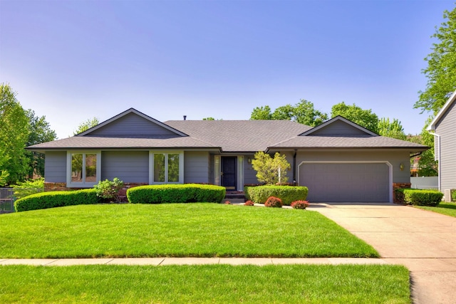 10760 Elmcrest Dr, Clive, IA 50325 - ranch-style house featuring an attached garage, concrete driveway, a front lawn, a shingled roof, and brick siding