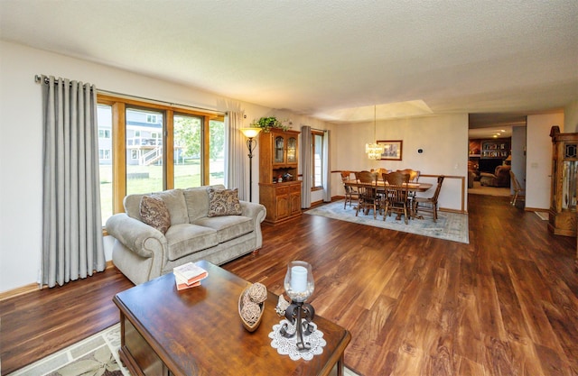 10760 Elmcrest Dr, Clive, IA 50325 - living area featuring wood finished floors, a chandelier, and baseboards