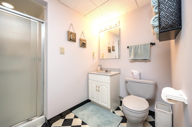 10760 Elmcrest Dr, Clive, IA 50325 - bathroom featuring tile patterned floors, a paneled ceiling, toilet, a stall shower, and vanity