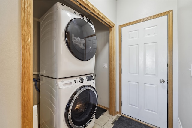 1416 Linden Cir, Adel, IA 50003 - laundry room with stacked washing machine and dryer, light tile patterned floors, and baseboards