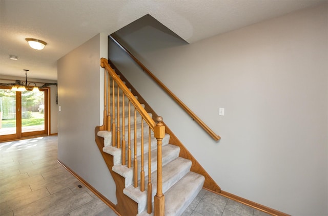 5433 NW 89th St, Johnston, IA 50131 - staircase with baseboards and a textured ceiling