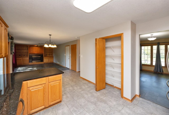 5433 NW 89th St, Johnston, IA 50131 - kitchen featuring baseboards, a chandelier, hanging light fixtures, a textured ceiling, and open floor plan