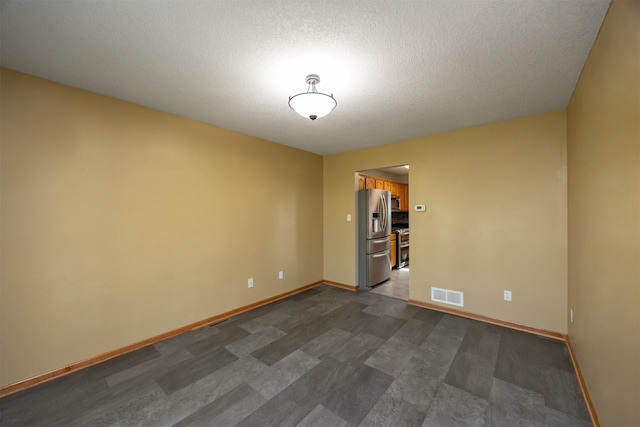 5433 NW 89th St, Johnston, IA 50131 - empty room with baseboards and a textured ceiling