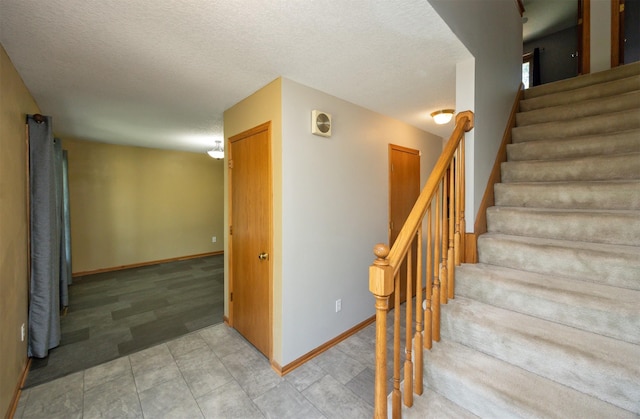 5433 NW 89th St, Johnston, IA 50131 - stairs with baseboards, a textured ceiling, and tile patterned floors