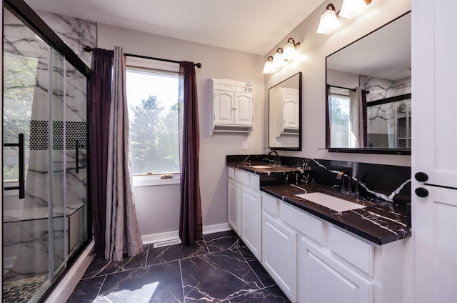 5433 NW 89th St, Johnston, IA 50131 - full bathroom featuring marble finish floors, a marble finish shower, double vanity, and baseboards