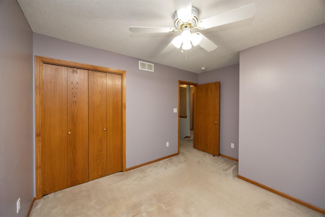 5433 NW 89th St, Johnston, IA 50131 - unfurnished bedroom featuring light colored carpet, baseboards, a closet, ceiling fan, and a textured ceiling
