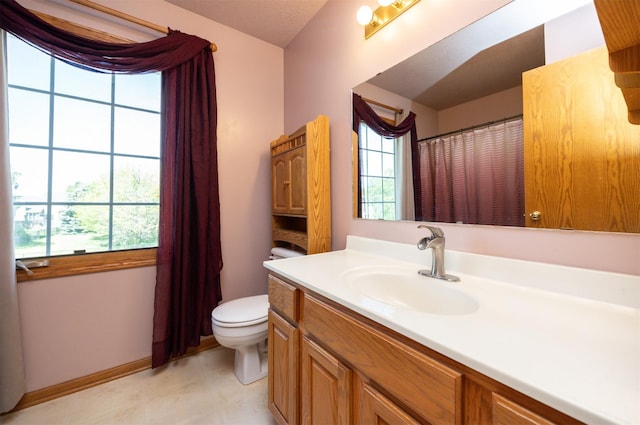 5433 NW 89th St, Johnston, IA 50131 - bathroom with toilet, vanity, baseboards, and a shower with shower curtain