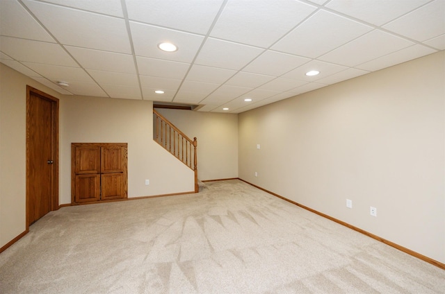 5433 NW 89th St, Johnston, IA 50131 - spare room with stairs, light carpet, recessed lighting, baseboards, and a paneled ceiling