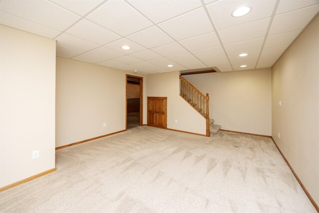 5433 NW 89th St, Johnston, IA 50131 - finished below grade area featuring light colored carpet, stairs, recessed lighting, baseboards, and a drop ceiling