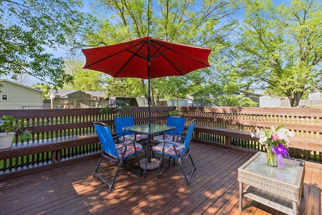 604 NE 8th St, Grimes, IA 50111 - wooden deck with outdoor dining space and a fenced backyard