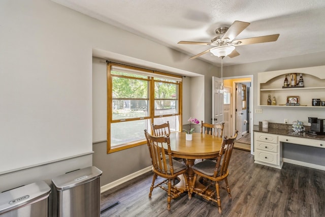 604 NE 8th St, Grimes, IA 50111 - dining space featuring ceiling fan, dark wood-type flooring, baseboards, a textured ceiling, and a desk