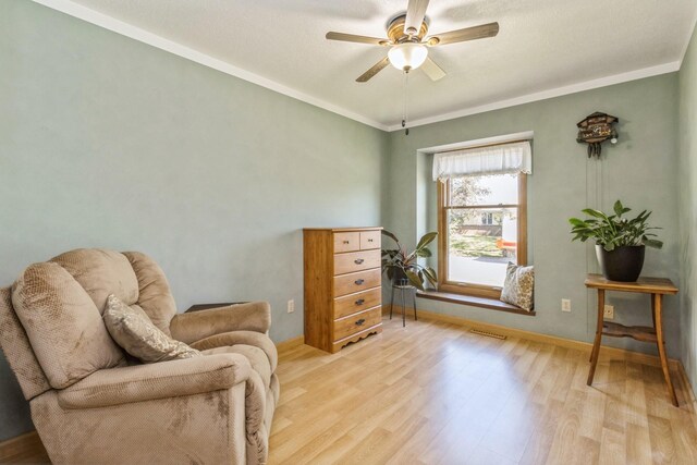 604 NE 8th St, Grimes, IA 50111 - living area featuring light wood-style flooring, ceiling fan, ornamental molding, and baseboards