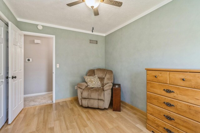 604 NE 8th St, Grimes, IA 50111 - living area featuring a ceiling fan, light wood-type flooring, and a textured ceiling