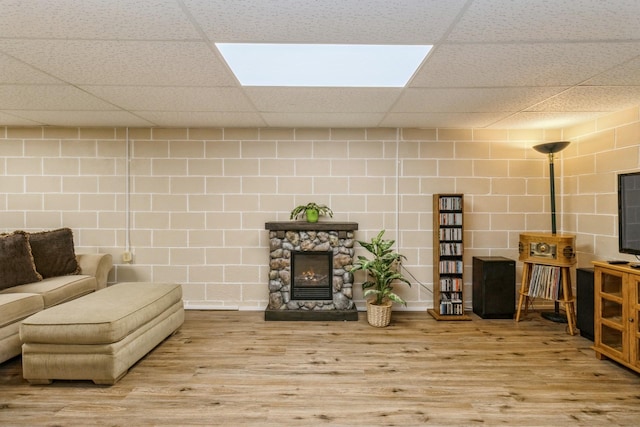604 NE 8th St, Grimes, IA 50111 - living area featuring a paneled ceiling, wood finished floors, and a stone fireplace