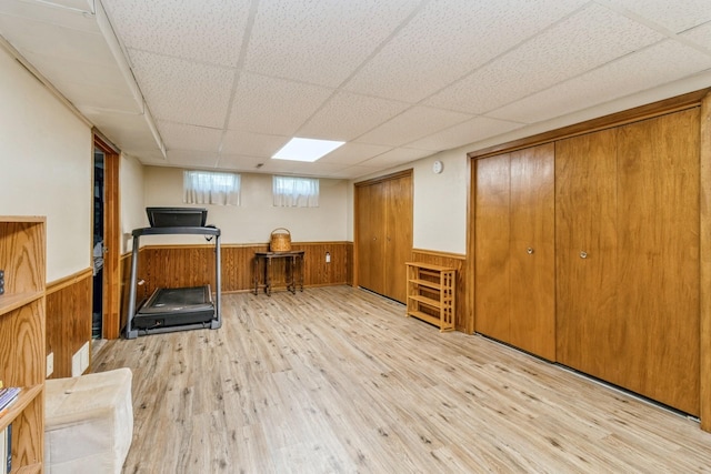 604 NE 8th St, Grimes, IA 50111 - workout area with a wainscoted wall, wood finished floors, wooden walls, and a drop ceiling