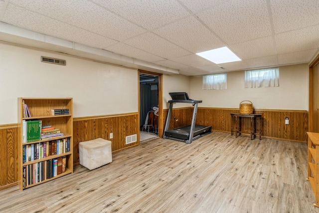 604 NE 8th St, Grimes, IA 50111 - exercise room with a wainscoted wall, wood finished floors, wood walls, and a drop ceiling