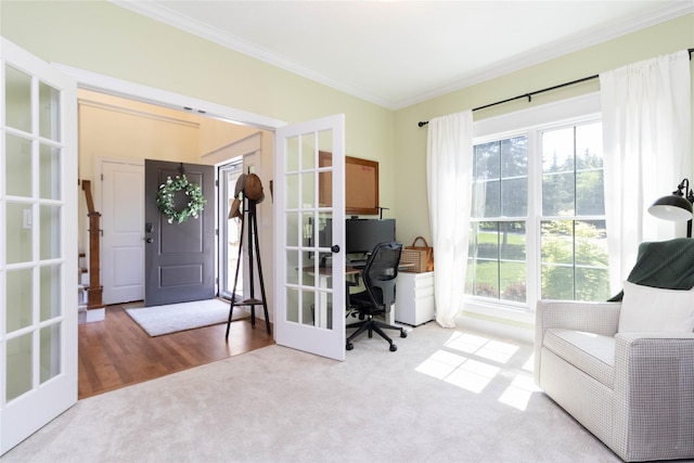carpeted home office with crown molding, plenty of natural light, and french doors