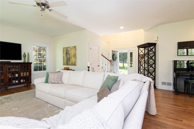living room with wood finished floors, stairs, a ceiling fan, recessed lighting, and baseboards