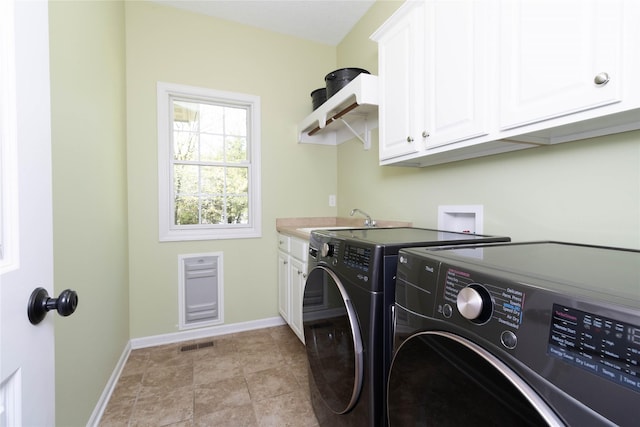 laundry room with washer and clothes dryer, cabinet space, and baseboards