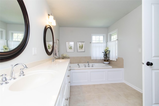 bathroom featuring tile patterned floors, a garden tub, and double vanity