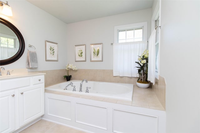 bathroom featuring a garden tub and vanity