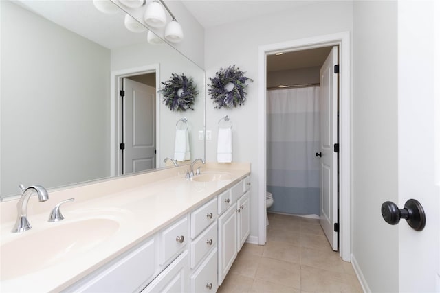 bathroom with toilet, double vanity, tile patterned floors, baseboards, and a shower with curtain