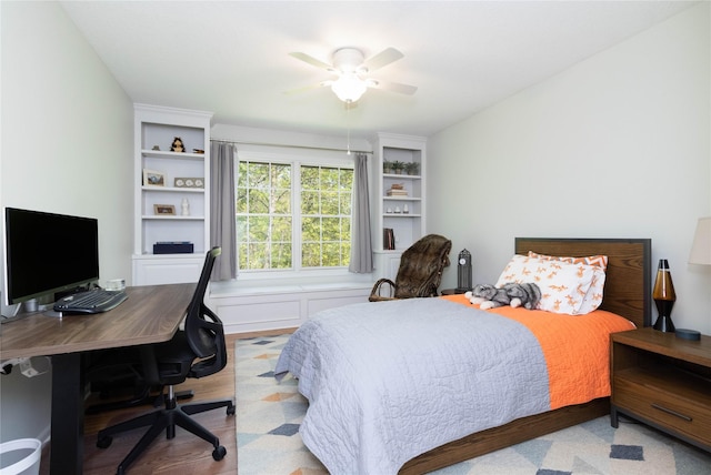 bedroom featuring a desk, wood finished floors, and a ceiling fan