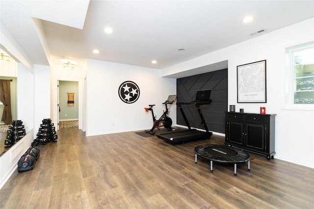 workout area with wood finished floors, recessed lighting, and baseboards