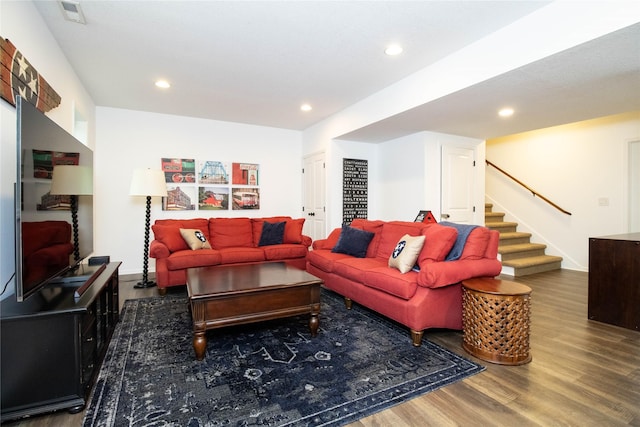 living area featuring wood finished floors, stairway, and recessed lighting