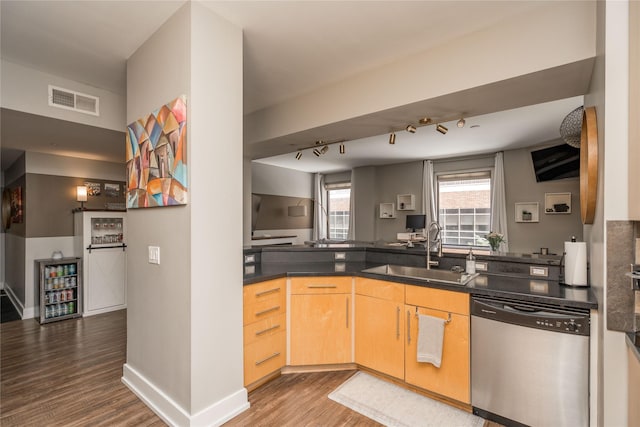 400 Walnut St Unit 201, Des Moines, IA 50309 - kitchen featuring dishwasher, a sink, light brown cabinetry, wood finished floors, and dark countertops
