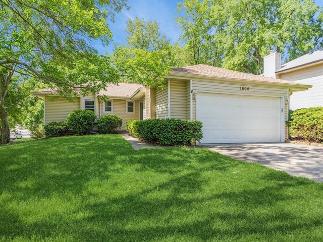 3800 Western Hills Dr, West Des Moines, IA 50265 - view of front facade featuring a garage, a chimney, driveway, and a front lawn