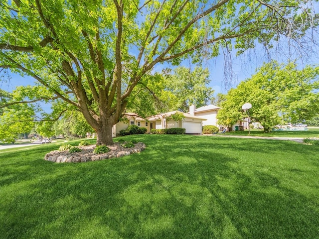 3800 Western Hills Dr, West Des Moines, IA 50265 - view of grassy yard with a garage
