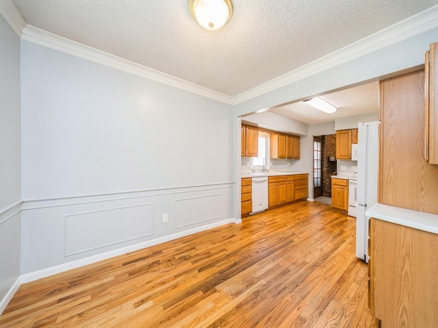 3800 Western Hills Dr, West Des Moines, IA 50265 - kitchen featuring white appliances, light wood finished floors, ornamental molding, light countertops, and a textured ceiling