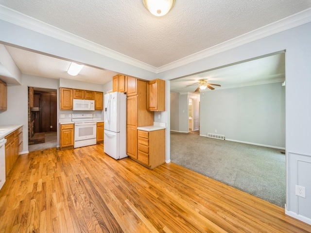 3800 Western Hills Dr, West Des Moines, IA 50265 - kitchen featuring white appliances, light countertops, light wood-style floors, baseboards, and a textured ceiling