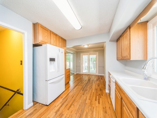 3800 Western Hills Dr, West Des Moines, IA 50265 - kitchen with white appliances, a sink, baseboards, light wood finished floors, and crown molding