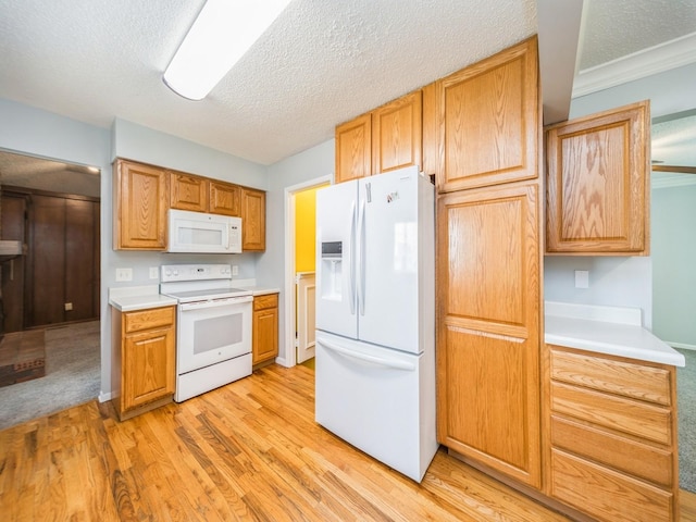 3800 Western Hills Dr, West Des Moines, IA 50265 - kitchen featuring white appliances, light wood-type flooring, light countertops, and a textured ceiling