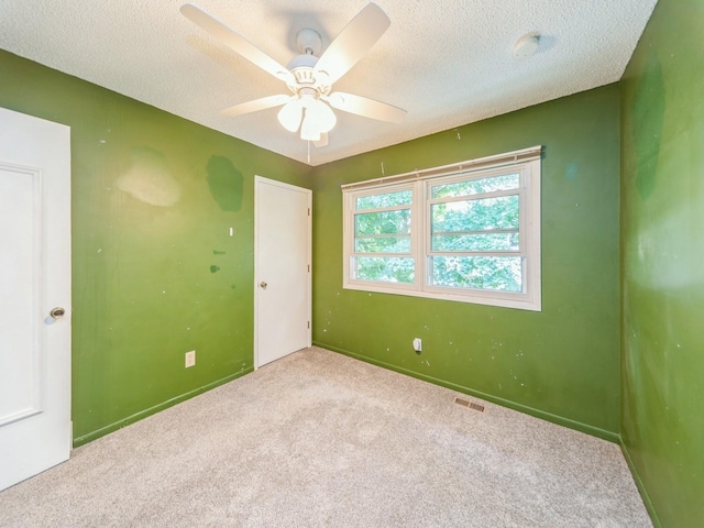 3800 Western Hills Dr, West Des Moines, IA 50265 - carpeted spare room featuring a ceiling fan, baseboards, a textured ceiling, and a smoke detector