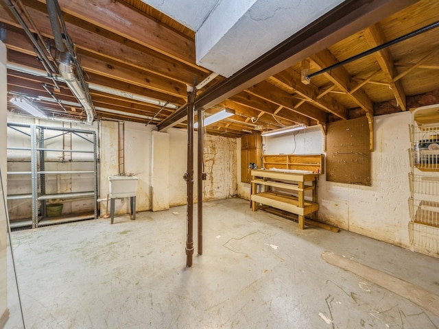 3800 Western Hills Dr, West Des Moines, IA 50265 - unfinished basement featuring a workshop area and a sink