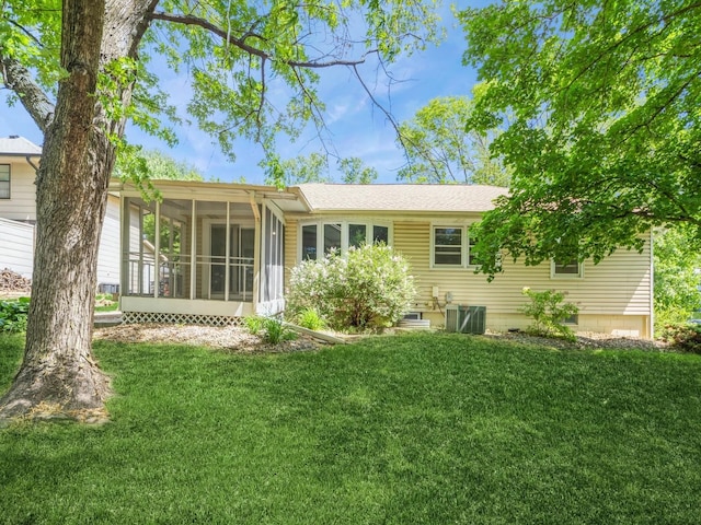 3800 Western Hills Dr, West Des Moines, IA 50265 - back of property featuring a sunroom, a yard, central AC, and roof with shingles