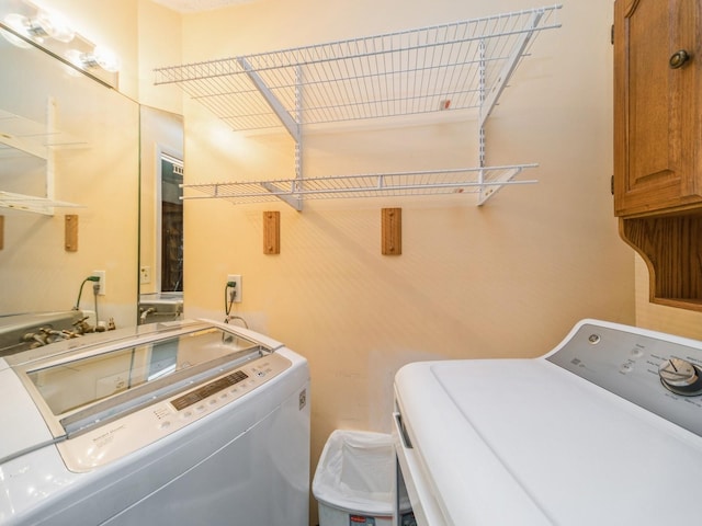 3800 Western Hills Dr, West Des Moines, IA 50265 - washroom with independent washer and dryer and cabinet space