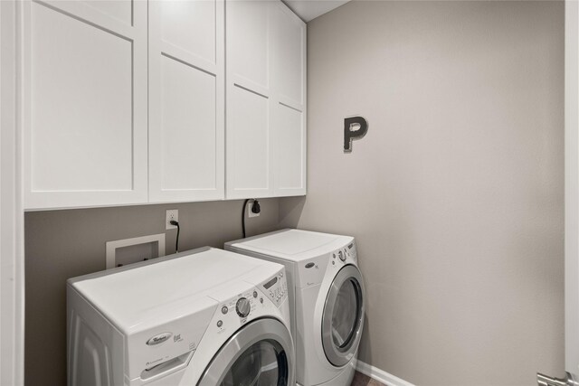 4400 132nd St, Urbandale, IA 50323 - laundry area featuring cabinet space and washing machine and dryer
