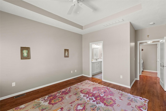 4400 132nd St, Urbandale, IA 50323 - bedroom with wood finished floors, baseboards, a ceiling fan, and connected bathroom