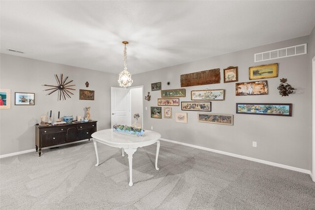 4400 132nd St, Urbandale, IA 50323 - dining room with carpet floors, a chandelier, and baseboards