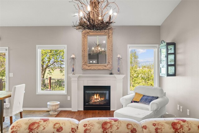 4400 132nd St, Urbandale, IA 50323 - sitting room with a chandelier, healthy amount of natural light, a glass covered fireplace, and wood finished floors